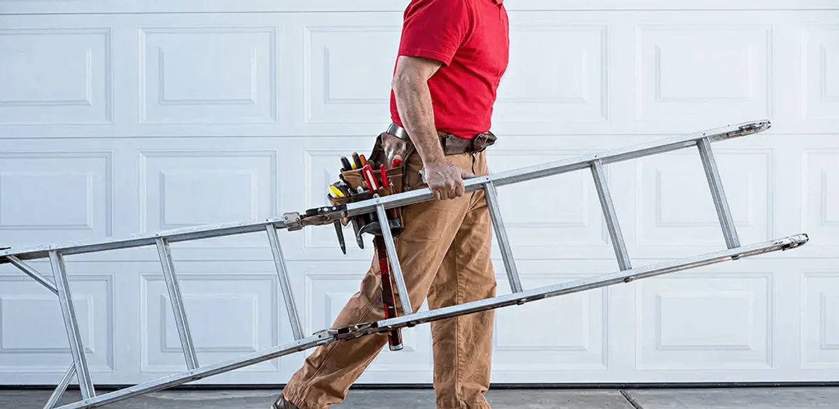 Garage door repair technician arriving with tools and ladder in Milwaukee, WI