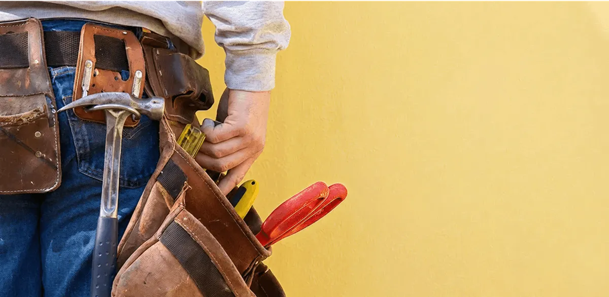 Handyman with tool belt ready for home repairs and maintenance in Milwaukee, WI